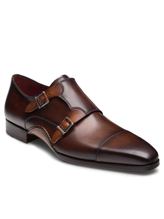 The Magnanni Leros in Tabaco/Cuero is a brown leather double monk strap shoe with Bologna construction, a low heel, two buckles, and a slightly pointed toe.