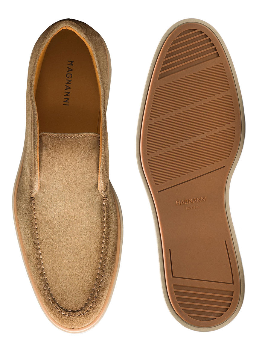 A pair of Magnanni Loda loafers in taupe suede, complete with a cushioned footbed for maximum comfort, displayed from the top and bottom views. Each shoe features a textured rubber sole, and the brand name "MAGNANNI" is visible on the inner heel and sole.