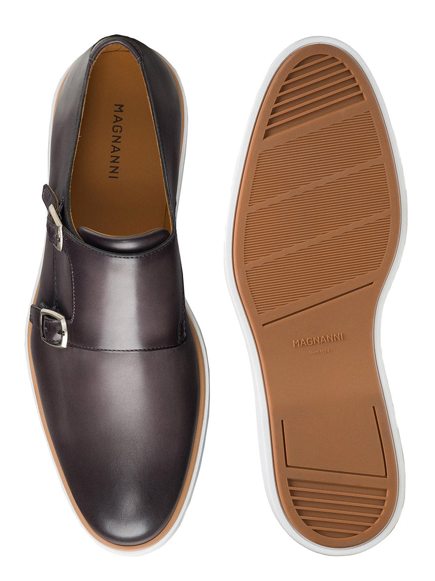 A pair of Magnanni Lucca in Grey with cushioned white rubber soles. The left shoe is displayed from the side, and the right shoe is shown from the sole view, highlighting their dress hybrid appeal. The brand "Magnanni" is visible inside.