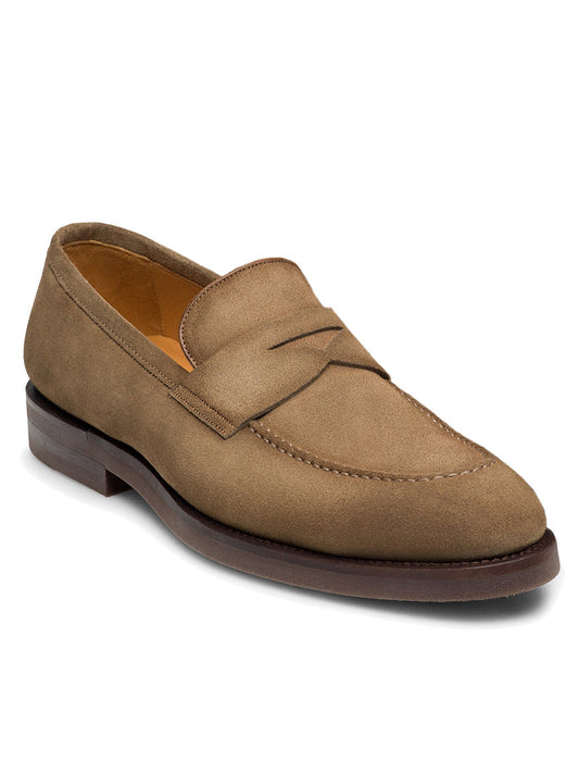 The Magnanni Lucien in Taupe Suede is a sleek penny loafer with a low heel, moc toe design, and a sophisticated strap detail across the top, making it perfect for smart-casual occasions.