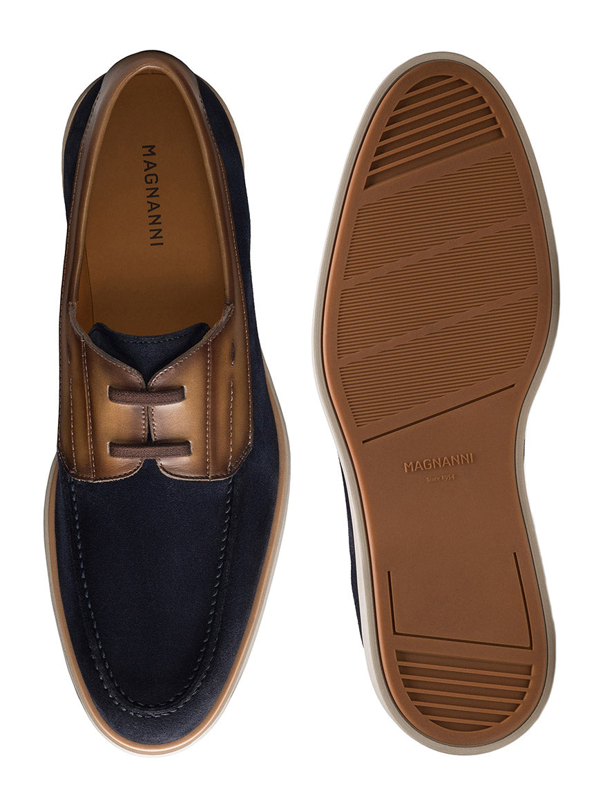 A pair of Magnanni Lucius men's dress shoes in Navy Suede/Brown. One shoe shows the top view, the other displays the sole, highlighting their Spanish craftsmanship and stylish design.