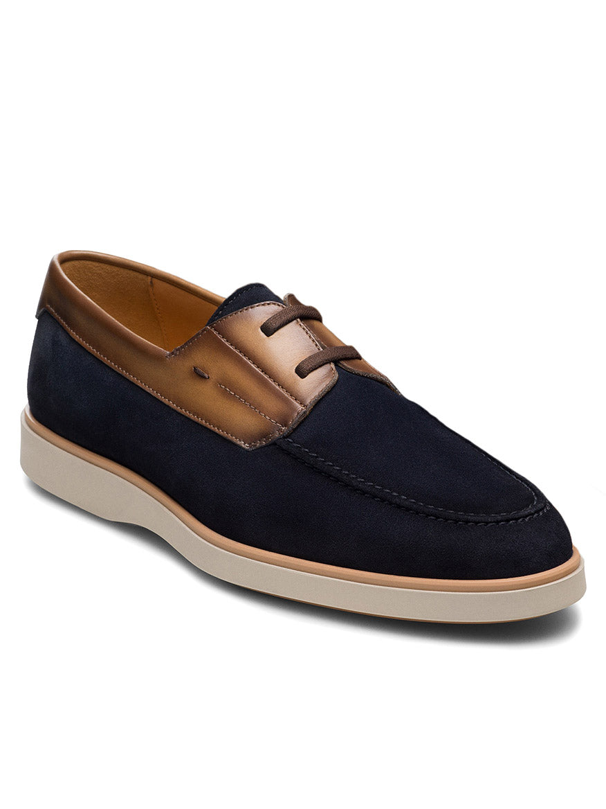 The Magnanni Lucius in Navy Suede/Brown is a men's nautical slip-on derby featuring navy blue suede, brown leather trim, beige laces, a light rubber sole, and a cushioned footbed for comfort.