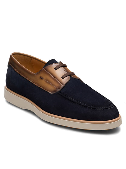 The Magnanni Lucius in Navy Suede/Brown is a men's nautical slip-on derby featuring navy blue suede, brown leather trim, beige laces, a light rubber sole, and a cushioned footbed for comfort.