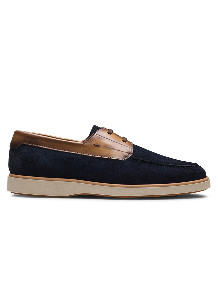 The Magnanni Lucius in Navy Suede / Brown is a nautical slip-on derby loafer featuring navy blue suede and brown leather, a beige rubber sole, and cushioned footbed, shown in side profile against a white background.
