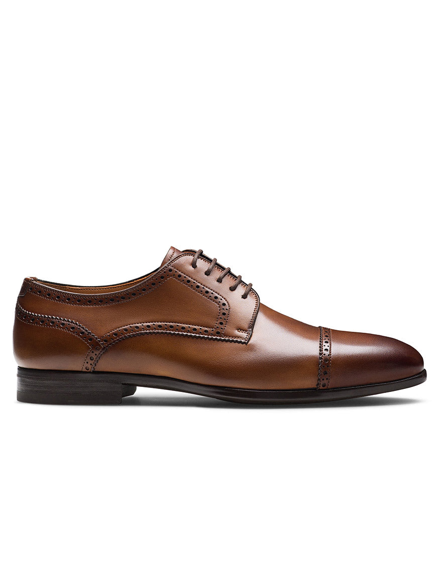 The Magnanni Macsen in Tabaco is a brown leather oxford brogue dress shoe with a cap toe, decorative stitching, and handcrafted Bologna construction, shown from the left side on a white background.