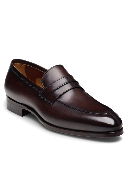 The Magnanni Marquis in Brown is a polished dark brown leather loafer featuring a rounded toe, low heel, and artisanal craftsmanship.