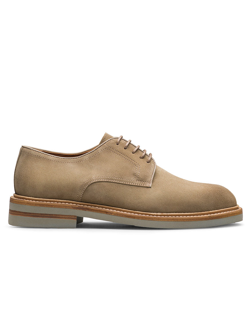 The Magnanni Marton in Taupe Suede is a men's plain toe derby shoe featuring brown laces, a stitched sole, and a low heel, shown in profile on a white background—perfect for smart-casual occasions.