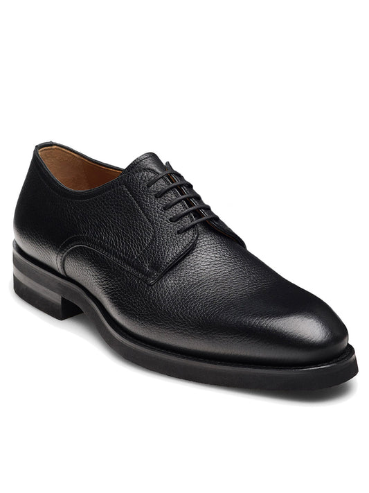 The Magnanni Melich V in Tumbled Black is a men's black leather Derby shoe with a textured finish, low heel, and rounded toe, shown on a white background.