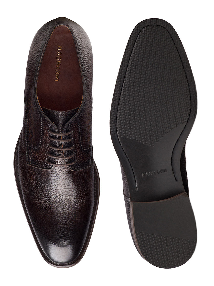 The Magnanni Melich V in Tumbled Brown is a pair of men's dark brown leather Derby shoes with classic laces, textured uppers, and smooth rubber soles—ideal smart-casual footwear for any occasion.