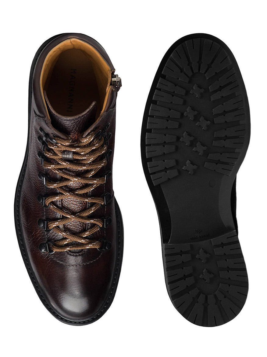 A pair of Magnanni Montana X in Brown leather boots is shown, one from the top view highlighting the laces, and the other from the bottom view showcasing the tread pattern of the sole. Featuring a modern hiking boot design, these Montana X boots blend rugged functionality with sleek style.