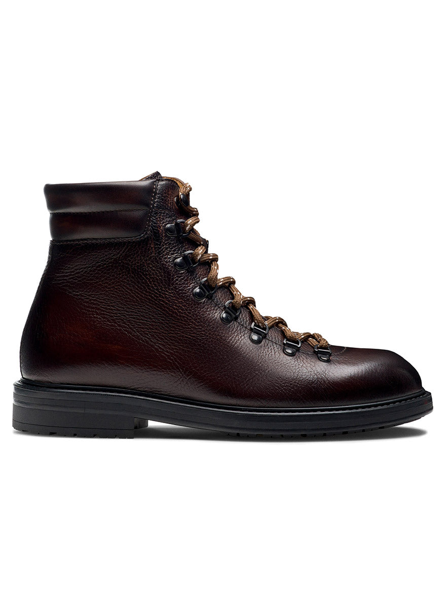 A side view of the Magnanni Montana X in Brown: a dark brown leather hiking boot featuring a cushioned ankle collar, black rubber sole, and brown laces threaded through metal eyelets. This modern hiking boot blends rugged durability with contemporary style.