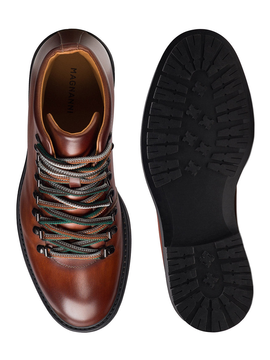 Top and bottom views of the Magnanni Montana X in Cognac, a modern hiking boot featuring brown leather, multicolored laces, and a rugged black rubber sole.