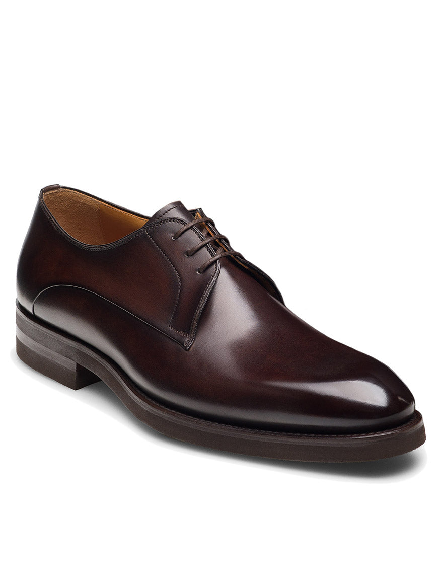 The Magnanni Omero in Brown is a men’s leather derby shoe with a plain toe, lace-up closure, and low heel, shown against a plain white background.