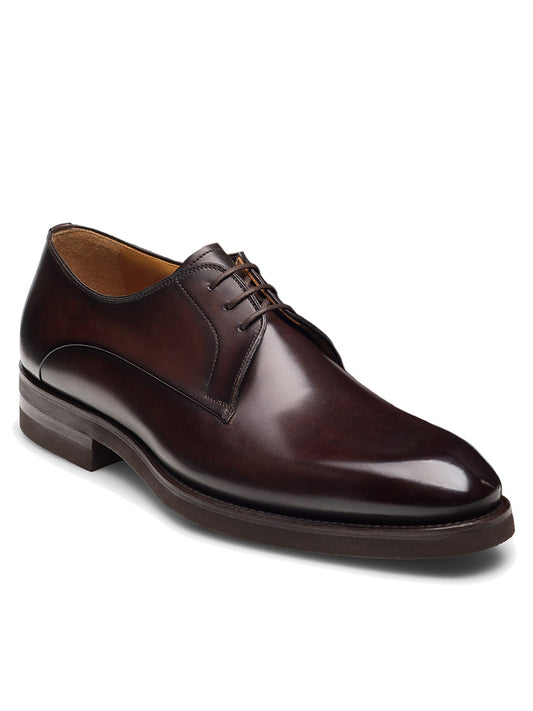 The Magnanni Omero in Brown is a men’s leather derby shoe with a plain toe, lace-up closure, and low heel, shown against a plain white background.