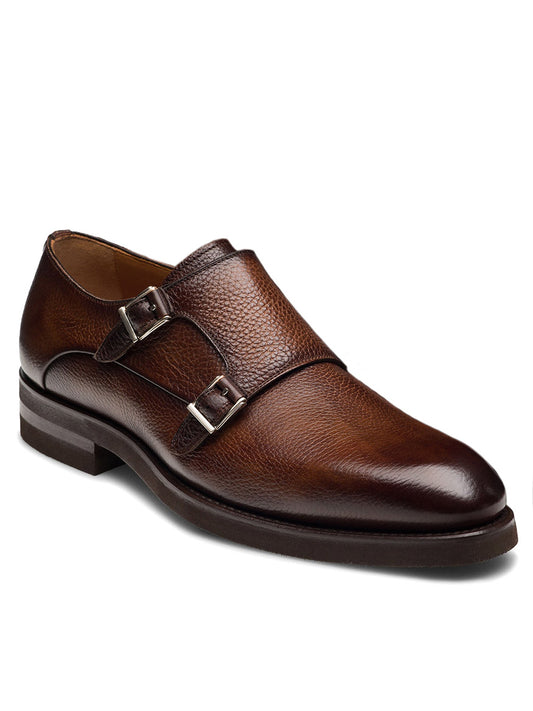 The Magnanni Omnia in Tumbled Tabaco is a brown leather double monk strap dress shoe with silver buckles, textured finish, and low heel, shown against a white background.