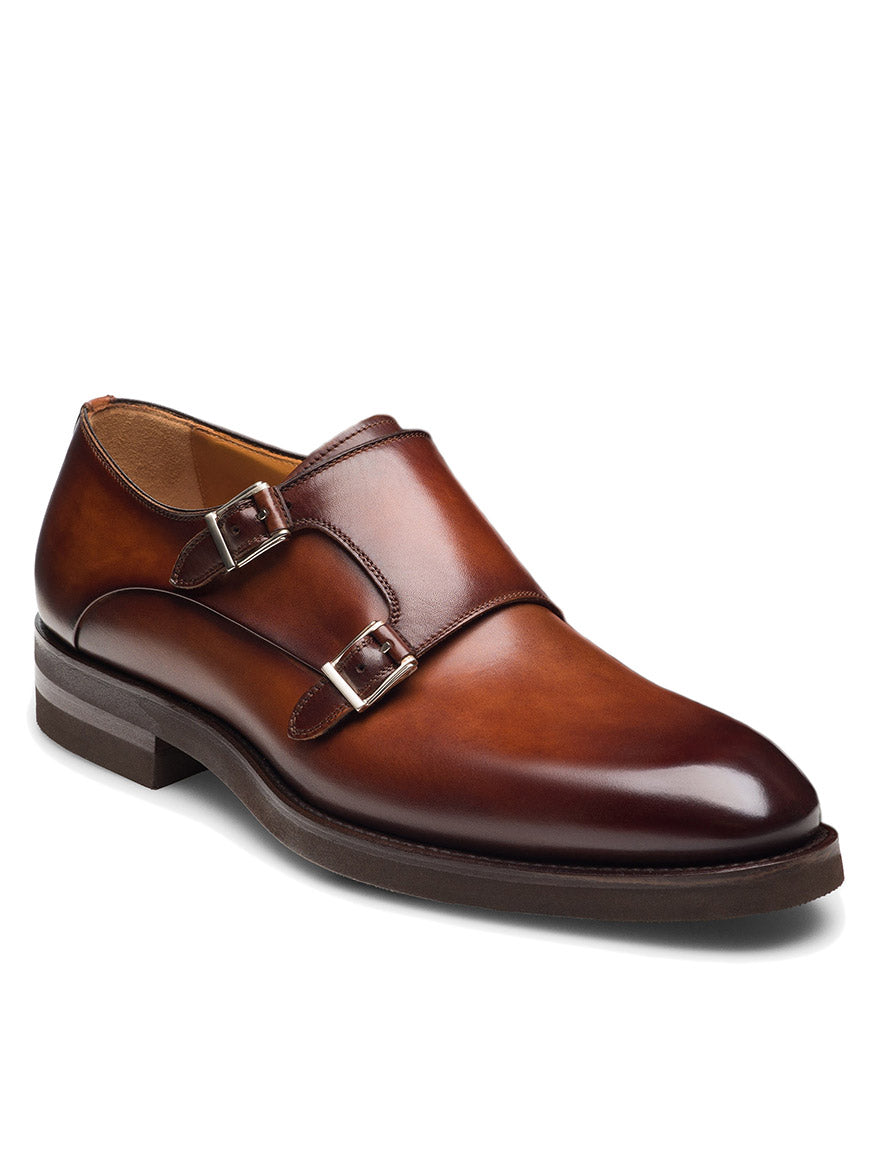 The Magnanni Omnia in Cognac is a brown leather double monk strap dress shoe with a polished finish and two silver buckles, displayed on a white background.