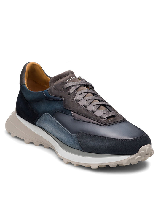 The Magnanni Onyx in Navy/Grey is a single sneaker featuring shades of gray, a textured sports sole, laces, and a luxury design with the brand name prominently displayed on the tongue.