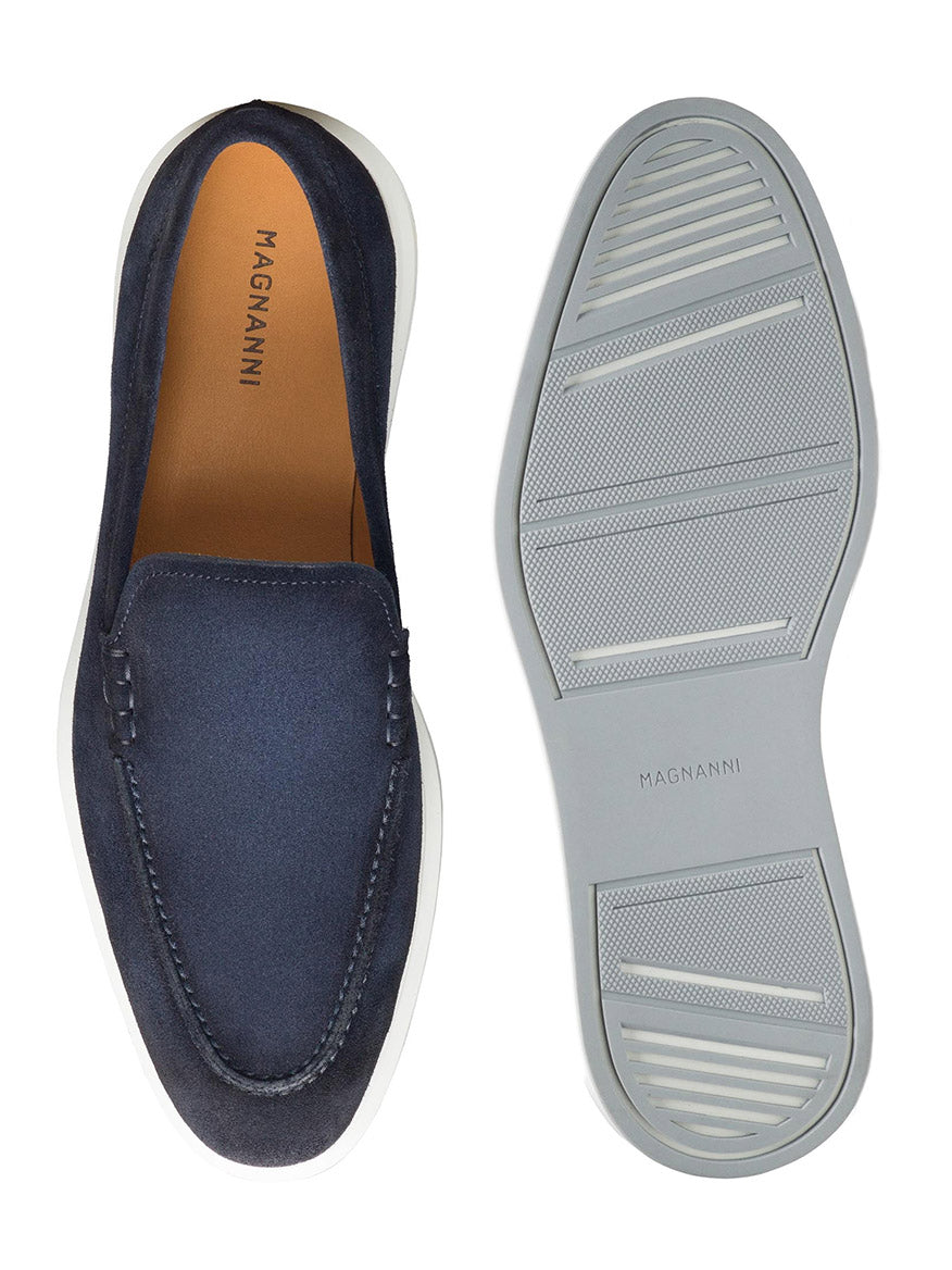 The Magnanni Orion in Navy Suede is featured, with one loafer shown from above and the other from the sole to showcase the design and tread pattern of these hybrid slip-on dress shoes.