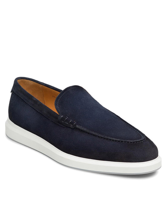 The Magnanni Orion in Navy Suede is a refined slip-on hybrid dress shoe with a white rubber sole, tan interior lining, minimal stitching, and everyday style.