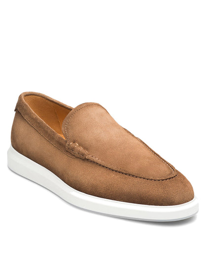 The Magnanni Orion in Taupe Suede is a slip-on loafer with visible stitching and a white rubber sole, featuring a dressy silhouette and shown at an angle on a plain white background.