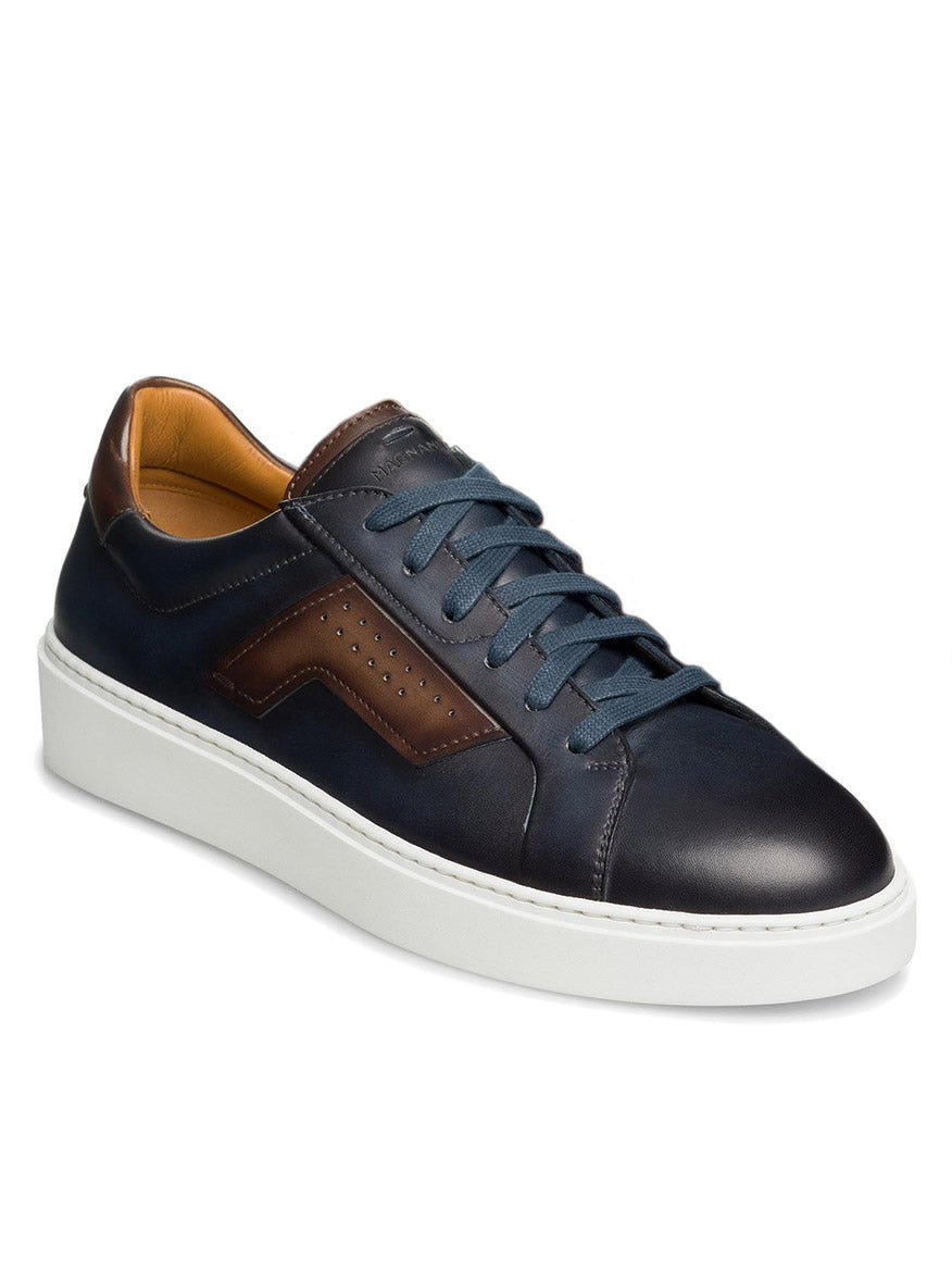 A single Magnanni Phoenix in Navy/Brown sneaker with sophisticated sporty appeal, featuring wing-inspired leather accents, a white rubber sole, and blue laces.