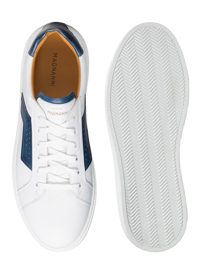 Top and sole view of a Magnanni Phoenix in White/Navy sneaker with white and blue leather accents, white laces, and a sporty appeal. The insole is labeled "MAGNANNI".