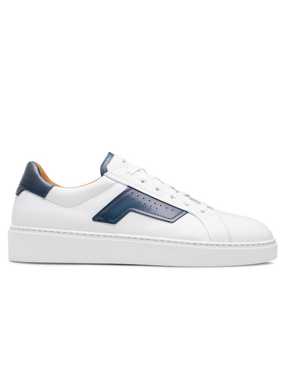 A white Magnanni Phoenix in White/Navy sneaker with a thick sole, featuring blue accents around the heel and a blue stripe along the side, effortlessly combines sporty appeal with subtle leather accents.