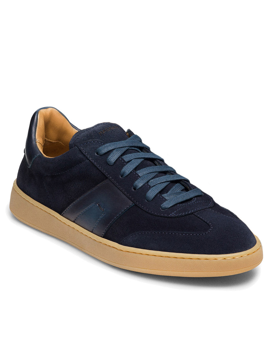 The Magnanni Primera in Navy Suede is a dark blue premium suede sneaker featuring matching laces and a tan gum sole.