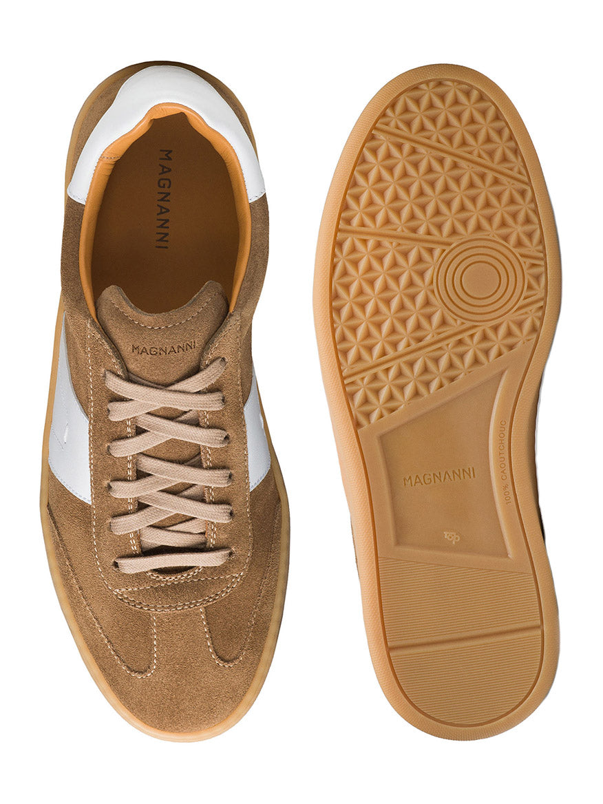 A pair of Magnanni Primera sneakers in taupe suede with white accents, viewed from above and the sole, showcasing their classic design and brand name on the inner sole and outsole.