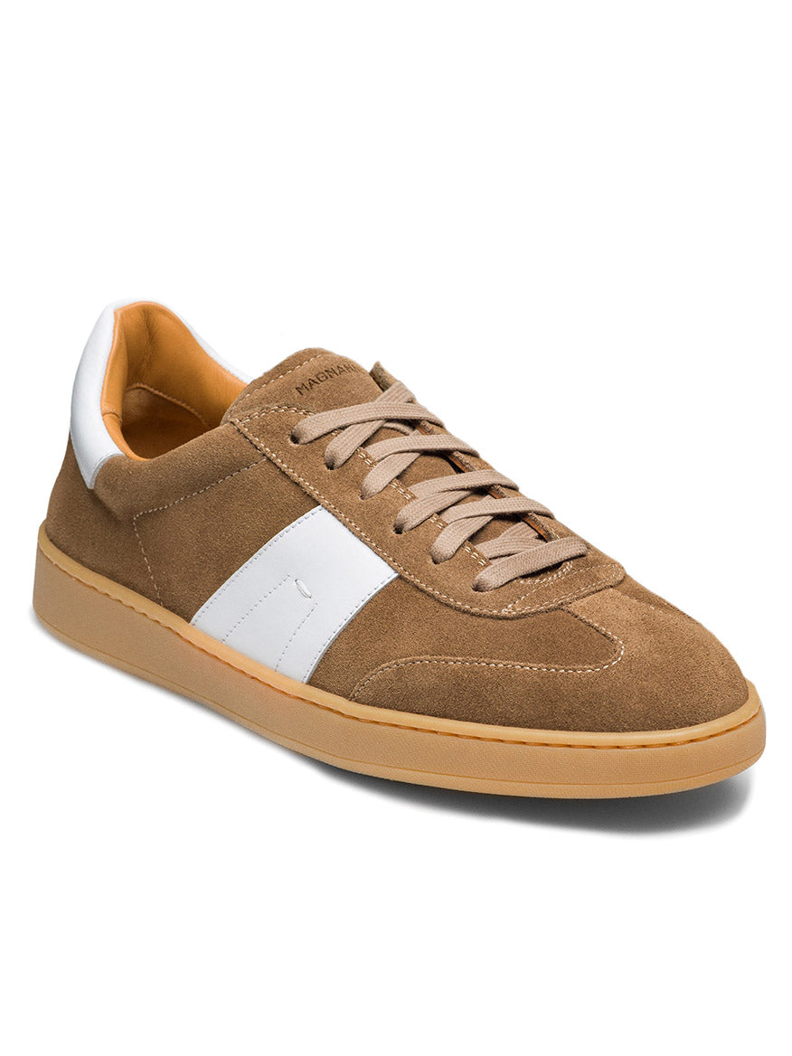 The Magnanni Primera in Taupe Suede & White features a brown and white suede design with a white side stripe, beige laces, and a tan rubber sole, showcasing premium suedes in a classic design.