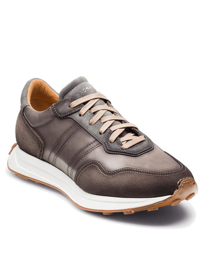 A single hand-stitched leather sneaker with a white sole, light brown laces, and three darker brown stripes on the side. Part of the Magnanni Romero II in Grey/Taupe collection, this sport sneaker epitomizes craftsmanship and style.