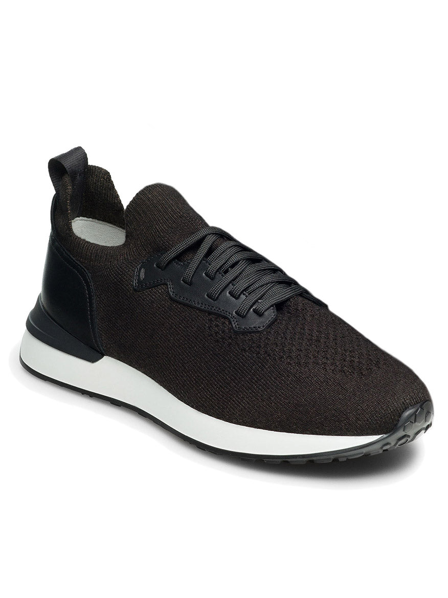 The Magnanni Stratus LyteKnit in Black is a stylish knit sneaker from the LyteKnit series, featuring knitted fabric, lace-up closure, a tab at the heel, a cushioned footbed, and a white sole.