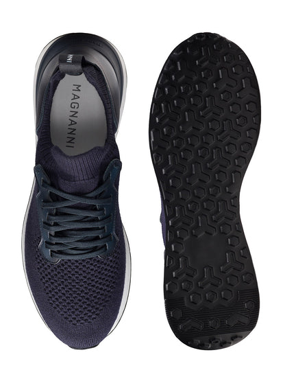 The Magnanni Stratus LyteKnit in Navy features a dark blue knit upper, laces, and a textured rubber sole, shown from top and bottom views. A cushioned footbed and "MAGNANNI" insole enhance comfort and showcase quality craftsmanship.