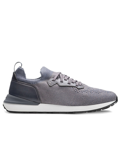 The Magnanni Stratus LyteKnit in Indigo, a lace-up knit sneaker with a cushioned footbed, white midsole, and dark outsole, is displayed in side profile on a white background.