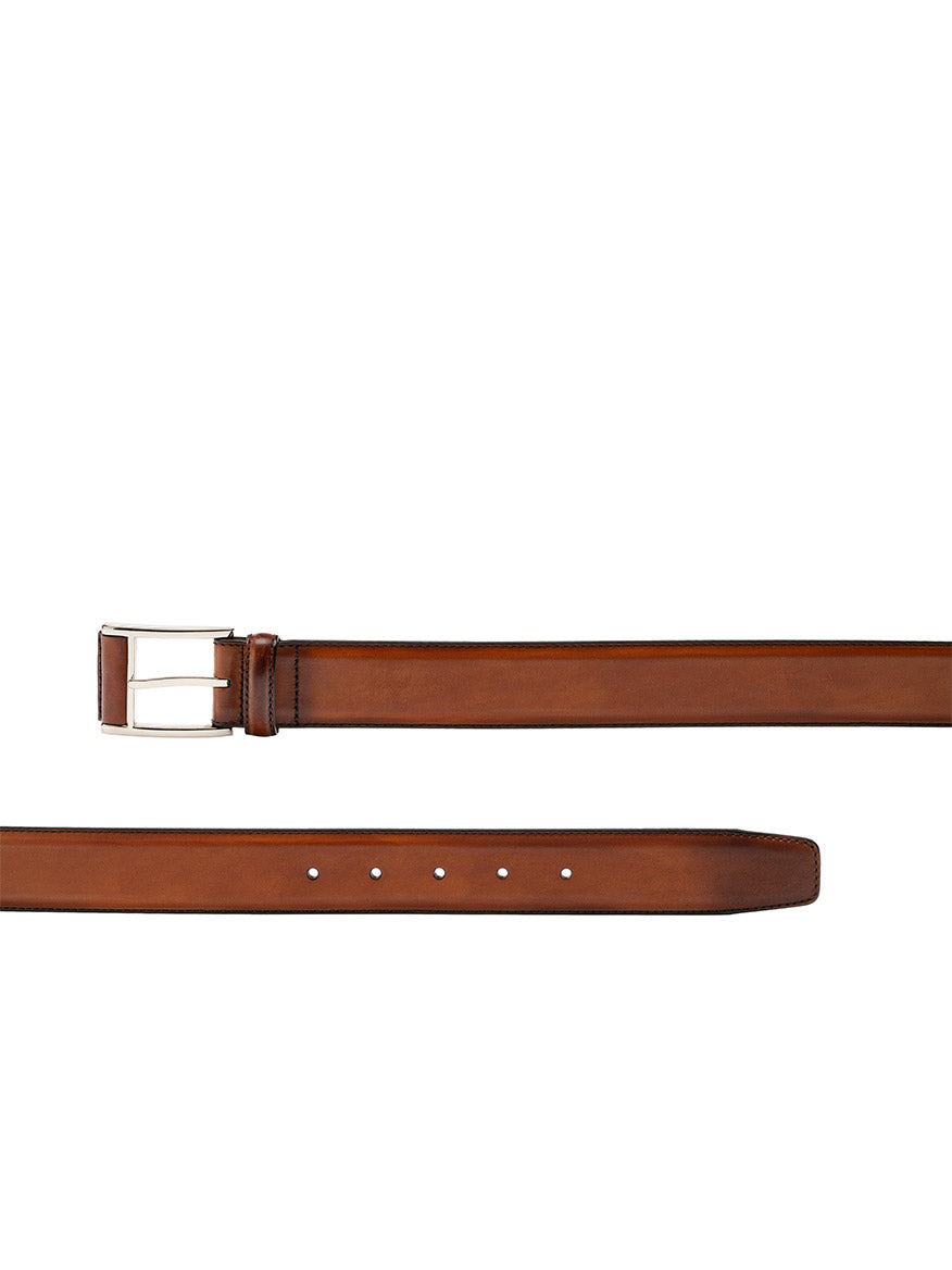 A luxurious Magnanni Velaz Belt in Cognac with a silver buckle, displayed horizontally on a white background.