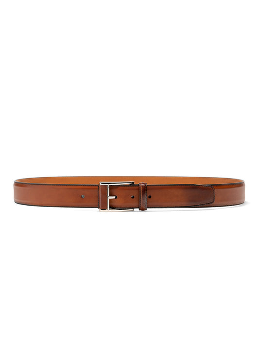 A luxurious Magnanni Velaz Belt in Cognac, with a silver buckle, displayed against a white background.
