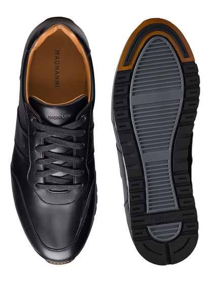 The Magnanni Ventura in Black men’s leather sneakers are shown from the top and sole, featuring laces and a rubber outsole with gray and black tread.