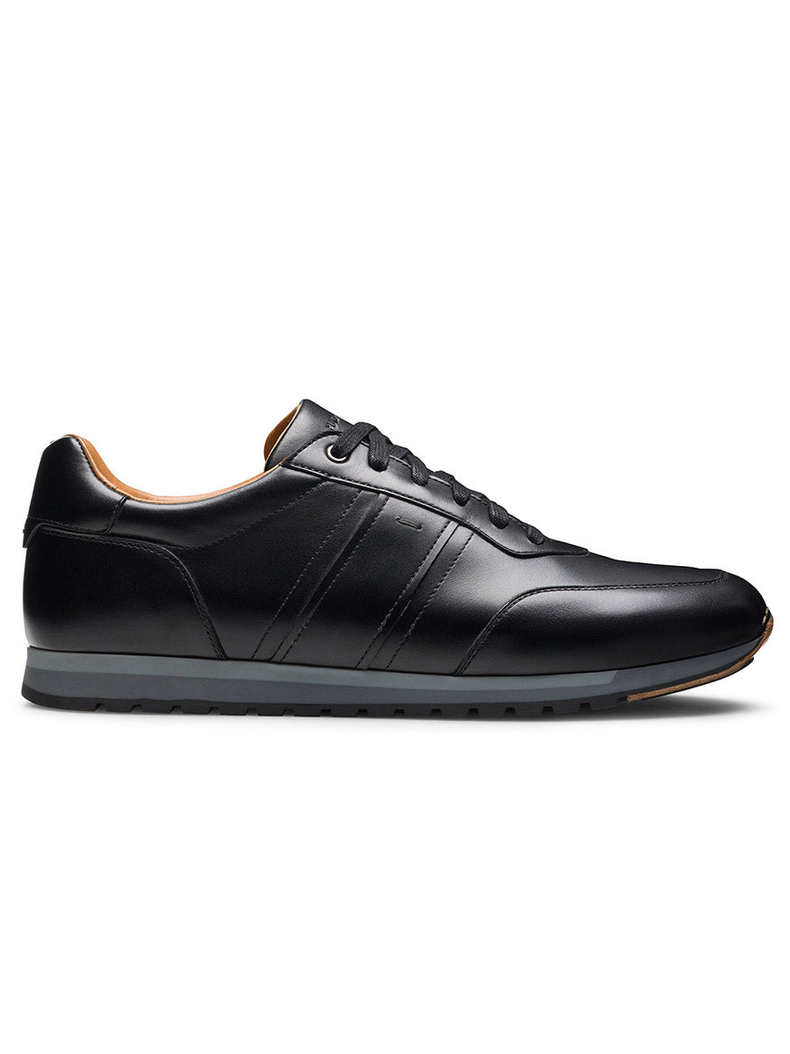 The Magnanni Ventura in Black is a men’s low-top leather sneaker featuring a lace-up closure and rubber sole, shown from the side on a white background.