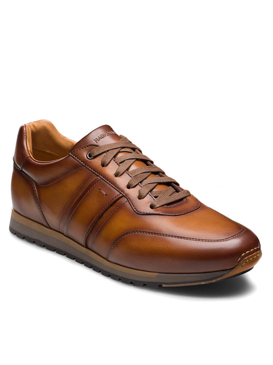The Magnanni Ventura in Cuero is a premium men's brown leather sneaker with matching laces and a rubber sole, shown angled on a white background.