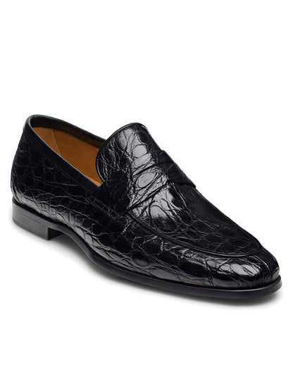 The Magnanni Vicente Croc in Black is a black leather penny loafer featuring a shiny, textured crocodile skin pattern and a luxurious Vicente Cognac interior lining.