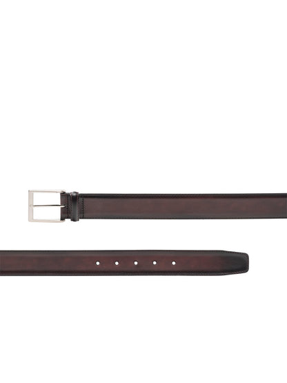 A Magnanni Viento Belt in Burgundy made of calfskin leather, featuring a brushed nickel buckle, displayed against a clean white background.