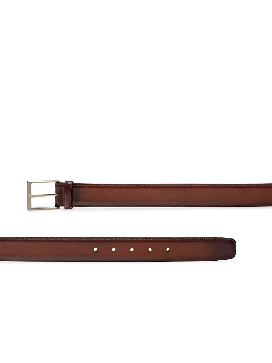 Magnanni Viento Belt in Cognac calfskin leather, featuring a brushed nickel rectangular buckle and multiple adjustment holes, displayed flat on a white background.