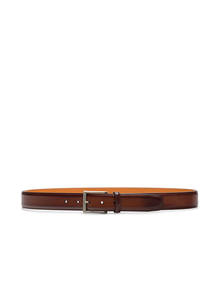 The Magnanni Viento Belt in Cognac, crafted from brown calfskin leather with a brushed nickel buckle, is shown laid flat against a white background.