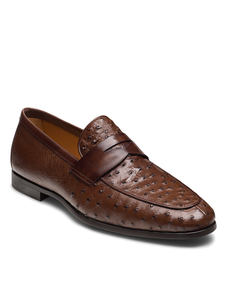 The Magnanni Viggo in Tabaco is a handcrafted men's loafer in brown ostrich leather, featuring a penny strap and textured, dotted upper—ideal for those seeking style and quality.