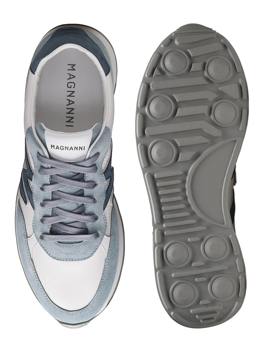 Top and bottom views of the Magnanni Yoki in Sky Blue Suede & Tumbled White, a retro-inspired sneaker made in Spain with a light blue, white, and gray upper and an athletic sole featuring textured rubber grip.