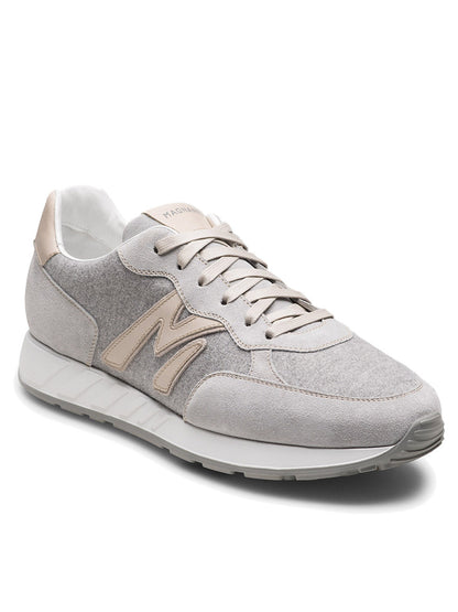 The Magnanni Yoki in Metal Suede & Bone is a retro-inspired sneaker in light gray and beige, featuring an athletic sole, suede and fabric panels, lace-up front, and a bold "M" logo on the side.