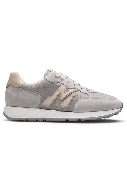 The Magnanni Yoki in Metal Suede & Bone is a light grey, retro-inspired sneaker with beige suede accents, white laces, a beige "M" logo, and an athletic-style sole shown from the left side profile.