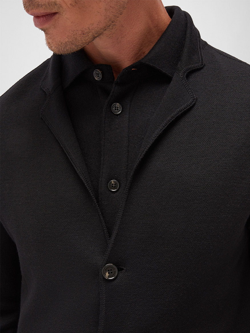 Close-up of a man wearing a Maurizio Baldassari Accademia Wool Swacket in Black with collar details, focusing on the chest and button closure.