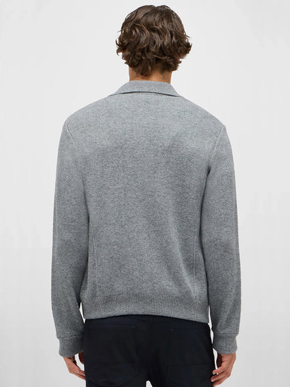 A person with short, wavy brown hair is shown from the back, wearing the Maurizio Baldassari Pique Knit Cashmere Blend Blouson in Light Grey and dark pants against a plain light background.