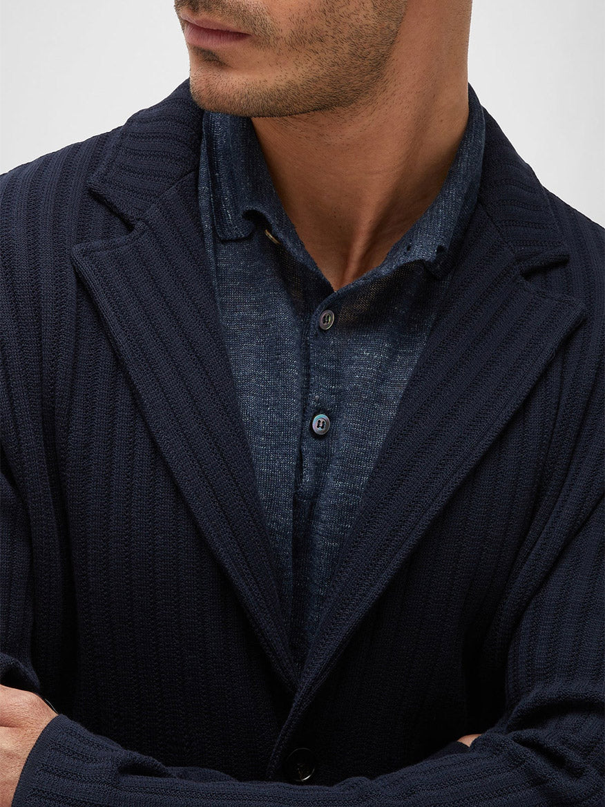Close-up of a man wearing a Maurizio Baldassari Cotton Pique Swacket in Navy over a gray shirt, focusing on the collar and top buttons.
